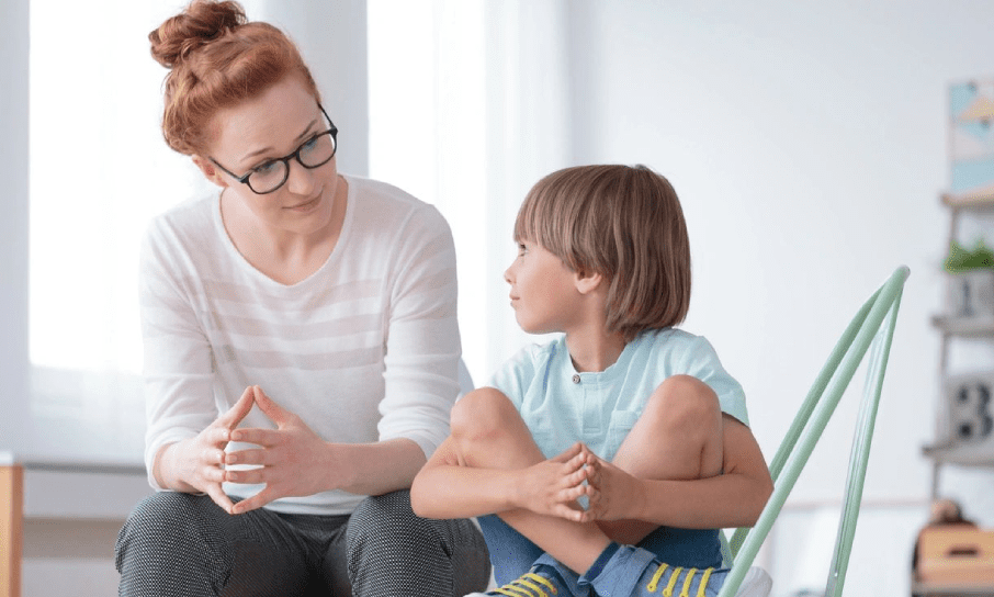 Clinical behavior specialist talking with young child